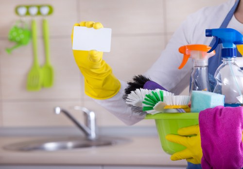 Professional carpet cleaner protecting furniture and flooring during service