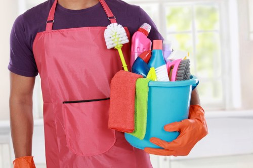 Protected cleaning staff wearing PPE during carpet cleaning work