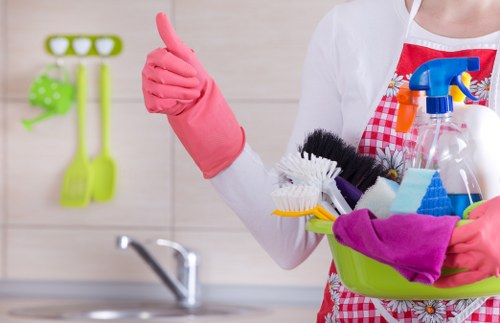 Carpet cleaning worker using safe procedures in an occupied property
